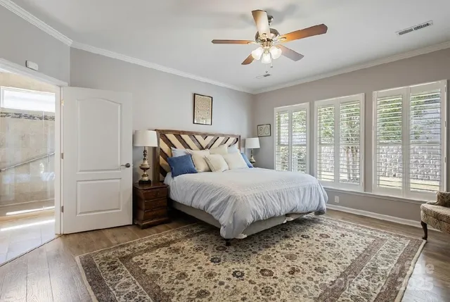 a spacious bedroom with a large bed and a chandelier