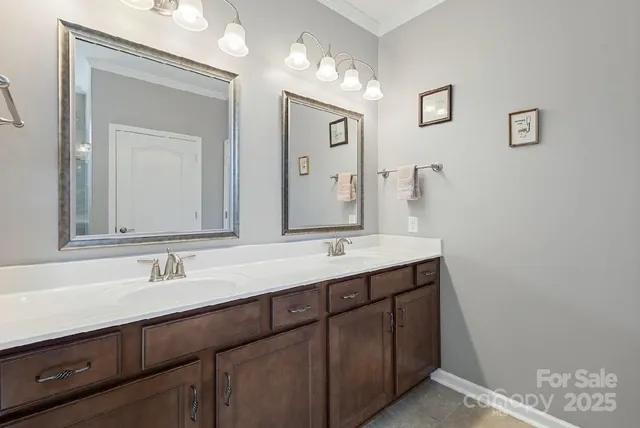 a bathroom with a double vanity sink and a mirror