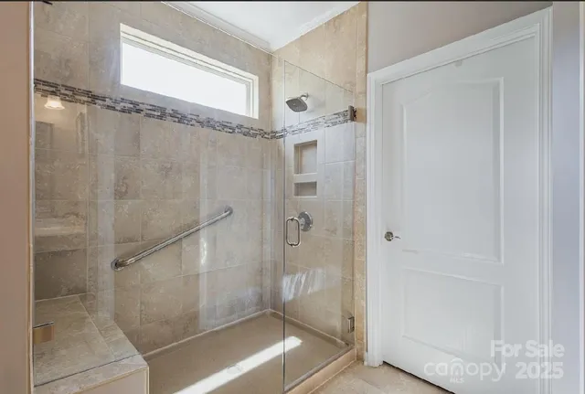 a bathroom with a glass shower door