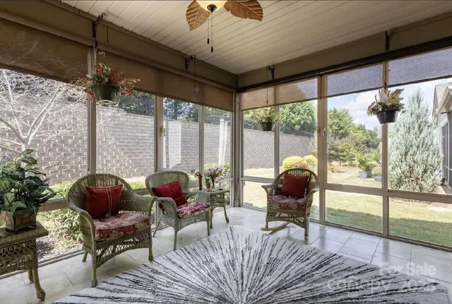 a living room with furniture and a floor to ceiling window