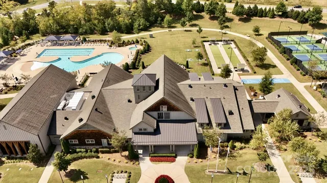 an aerial view of a residential houses with outdoor space