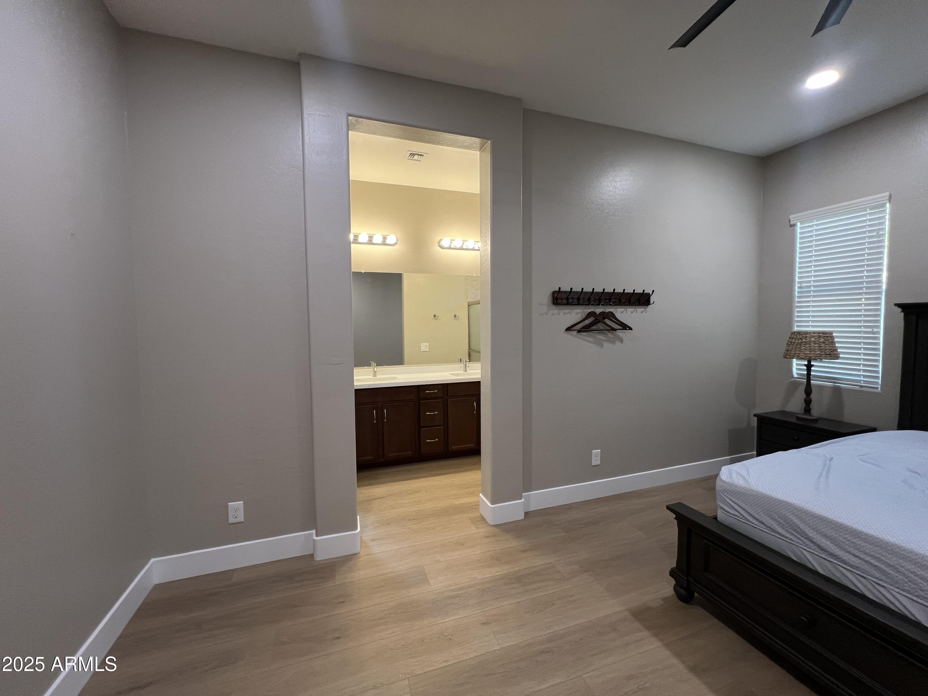 20480 West Point Ridge Road Buckeye, AZ 85396 - Photo 11 of 16 a bedroom with a bed and a view of bathroom