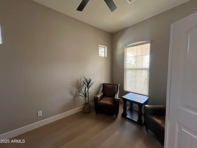 a view of a workspace with furniture and a window
