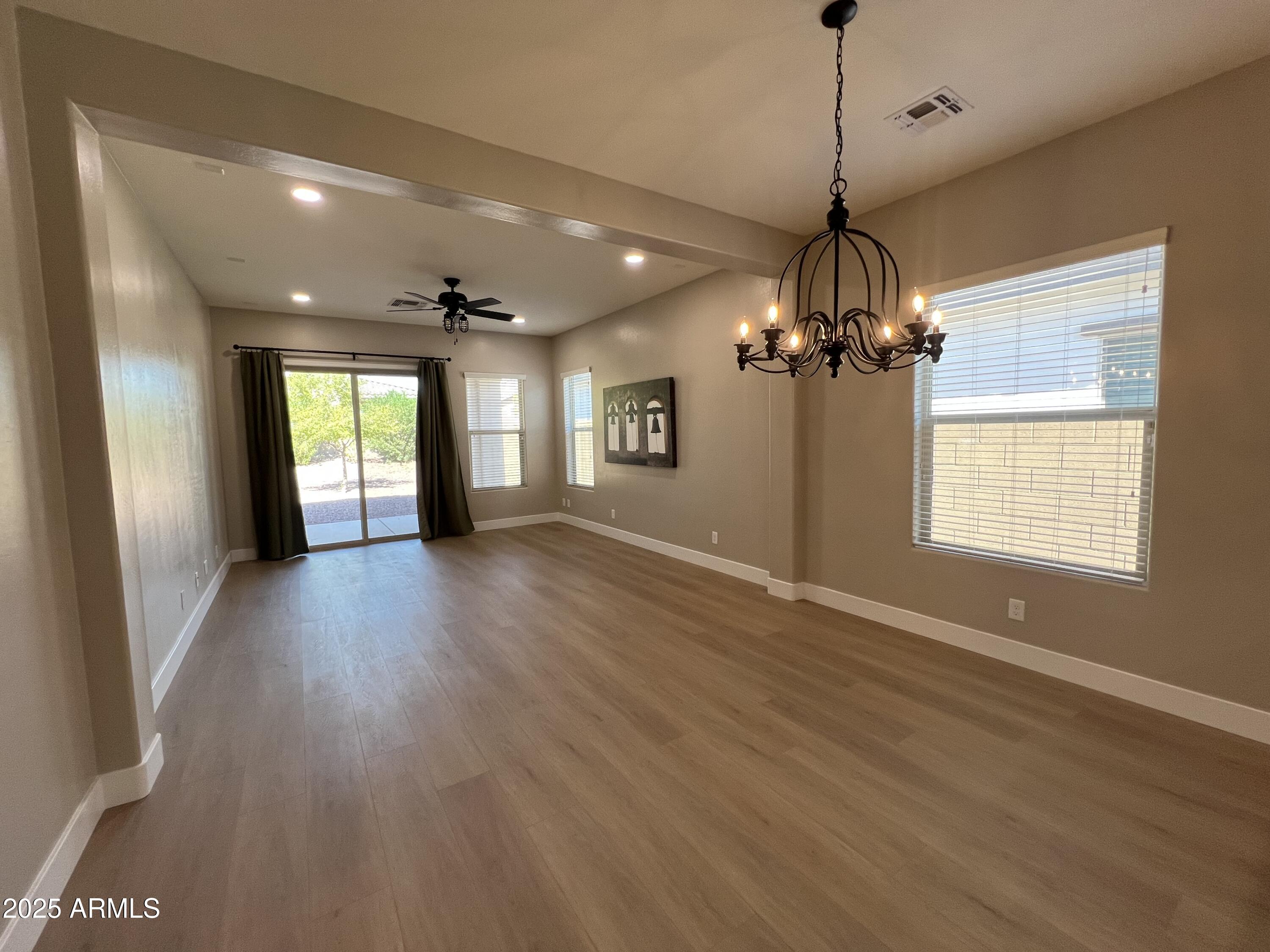 20480 West Point Ridge Road Buckeye, AZ 85396 - Photo 6 of 16 a view of an empty room with wooden floor and a window