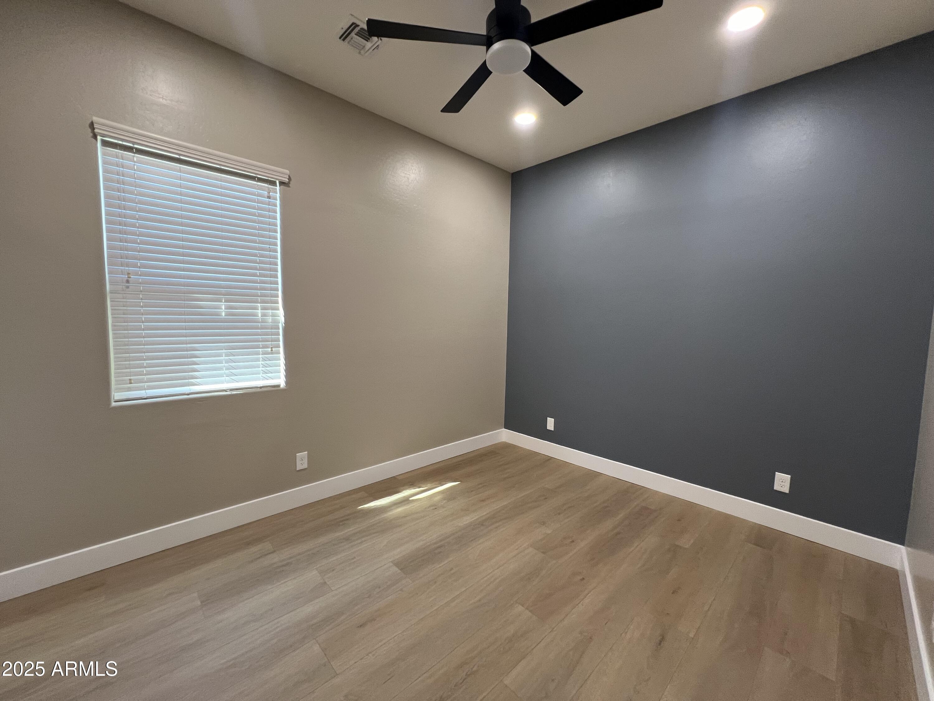 20480 West Point Ridge Road Buckeye, AZ 85396 - Photo 9 of 16 an empty room with a window and a ceiling fan