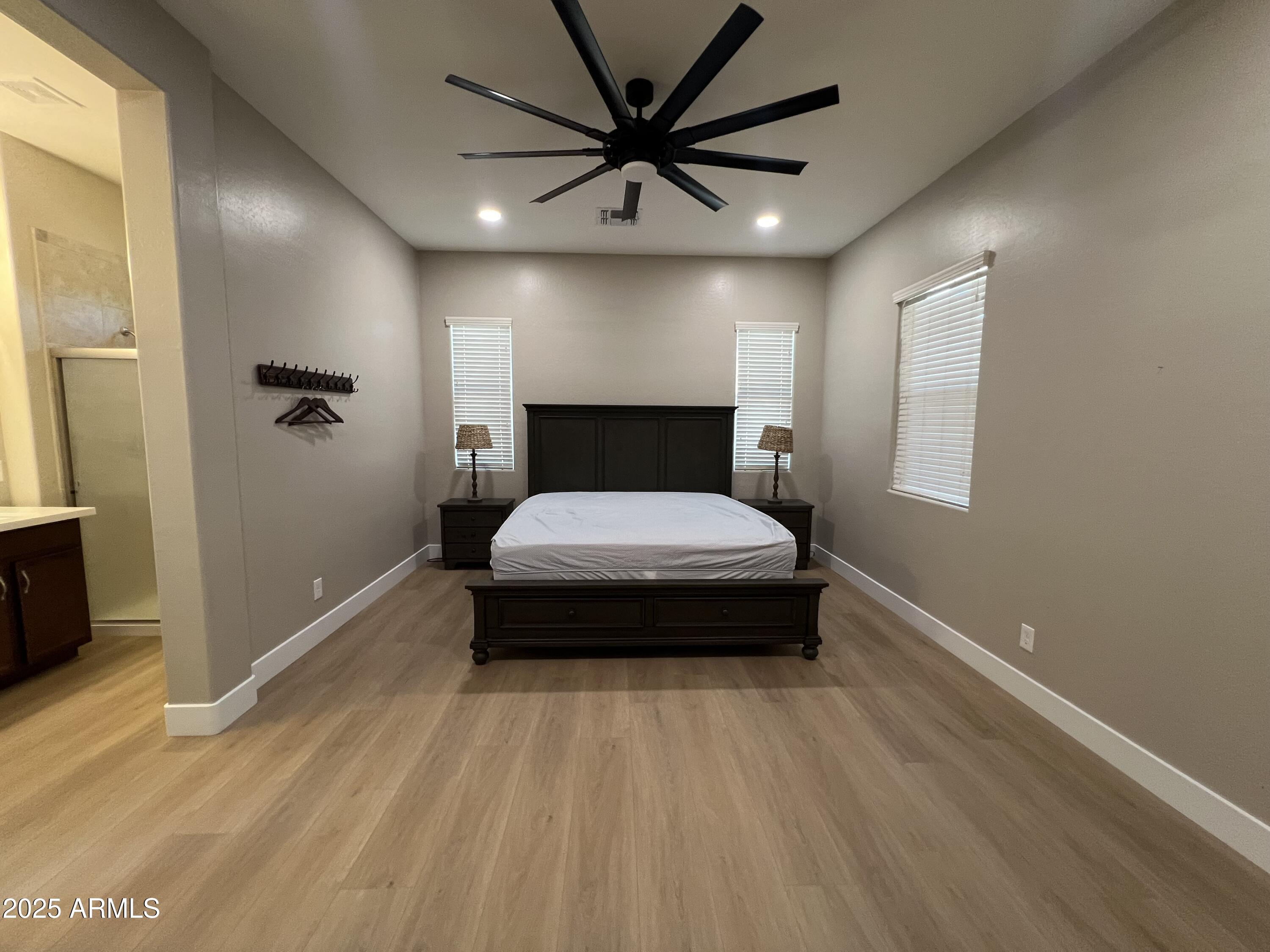 20480 West Point Ridge Road Buckeye, AZ 85396 - Photo 10 of 16 a bedroom with a bed and a chandelier