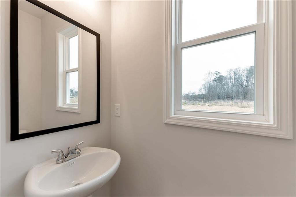 106 Windmill Court Calhoun, GA 30701 - Photo 12 of 29 a bathroom with a sink mirror and a window