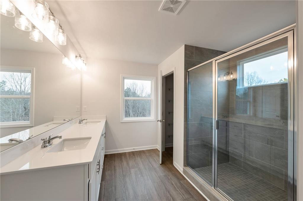 106 Windmill Court Calhoun, GA 30701 - Photo 17 of 29 a bathroom with a sink shower and a mirror
