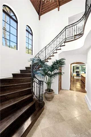 a view of a white house with a flower garden