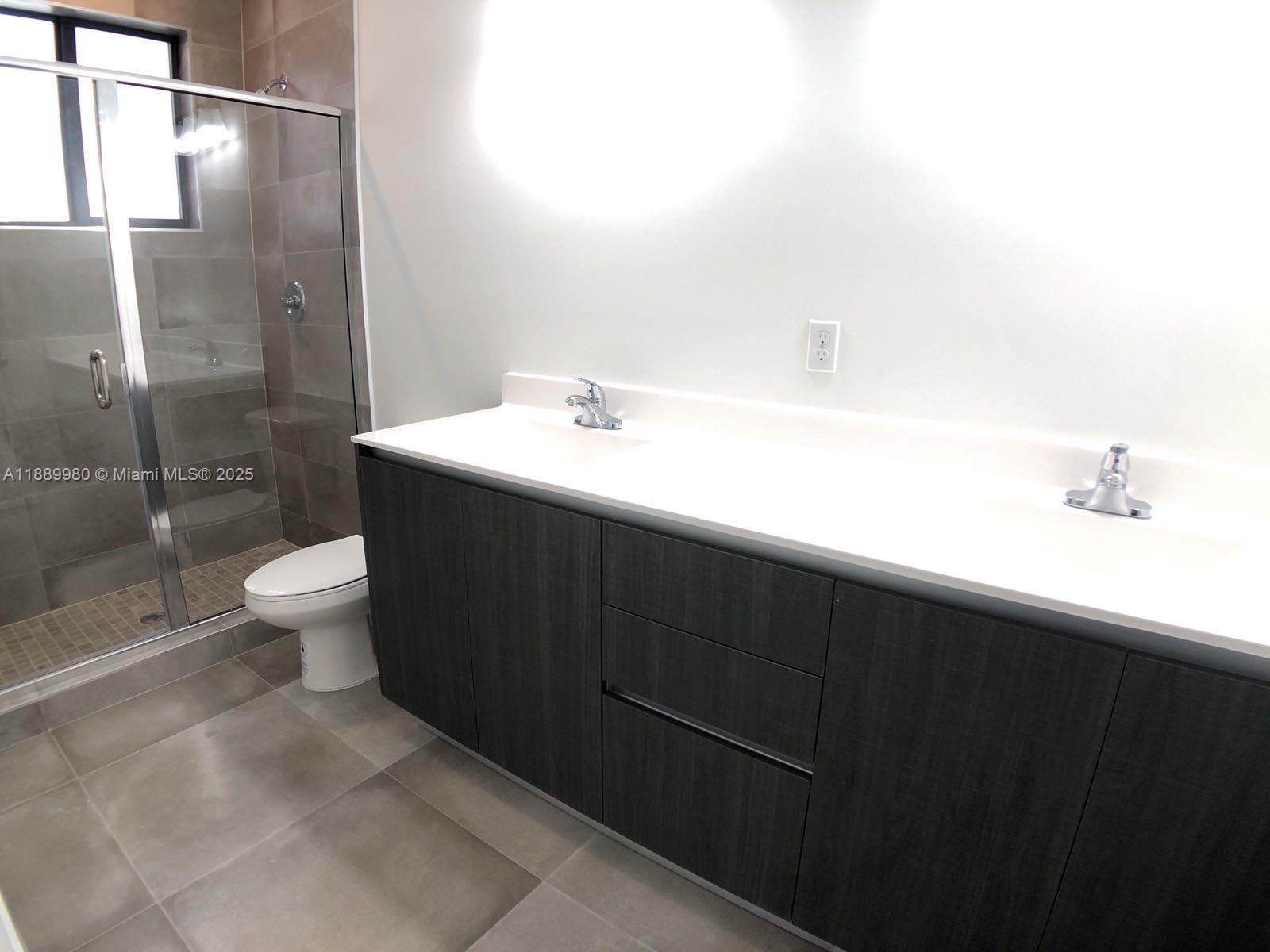 497 Southwest 91st Court, Unit 497 Miami, FL 33174 - Photo 3 of 8 a bathroom with a sink toilet and shower