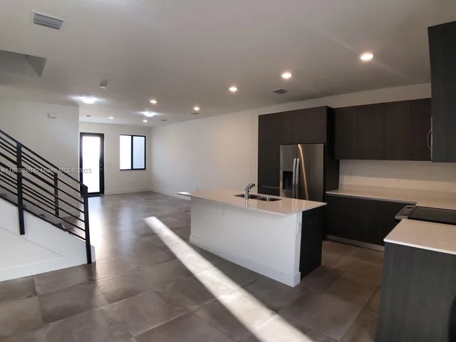 a view of living room with furniture and a flat screen tv