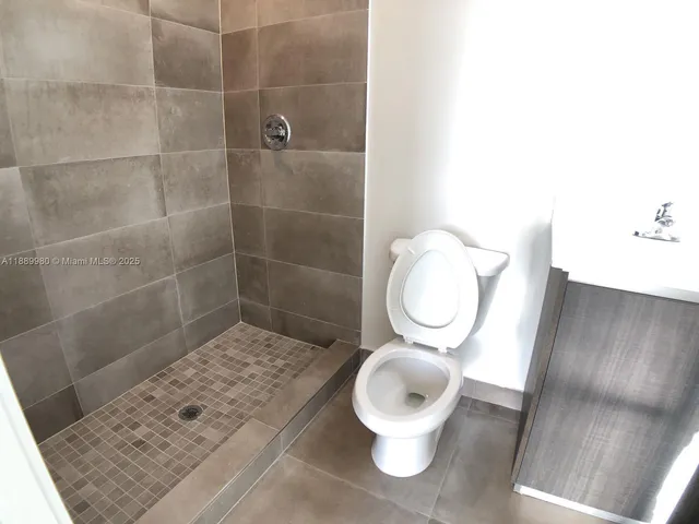 a white toilet sitting next to a bathroom sink