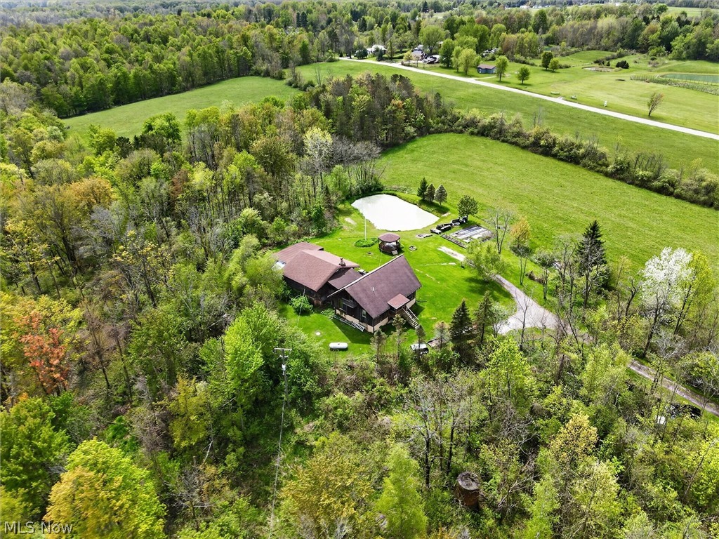 1526 Stevenson Road Ashtabula, OH 44004 - Photo 5 of 50 Sprawling property featuring a private pond, extensive green lawns, and a long driveway