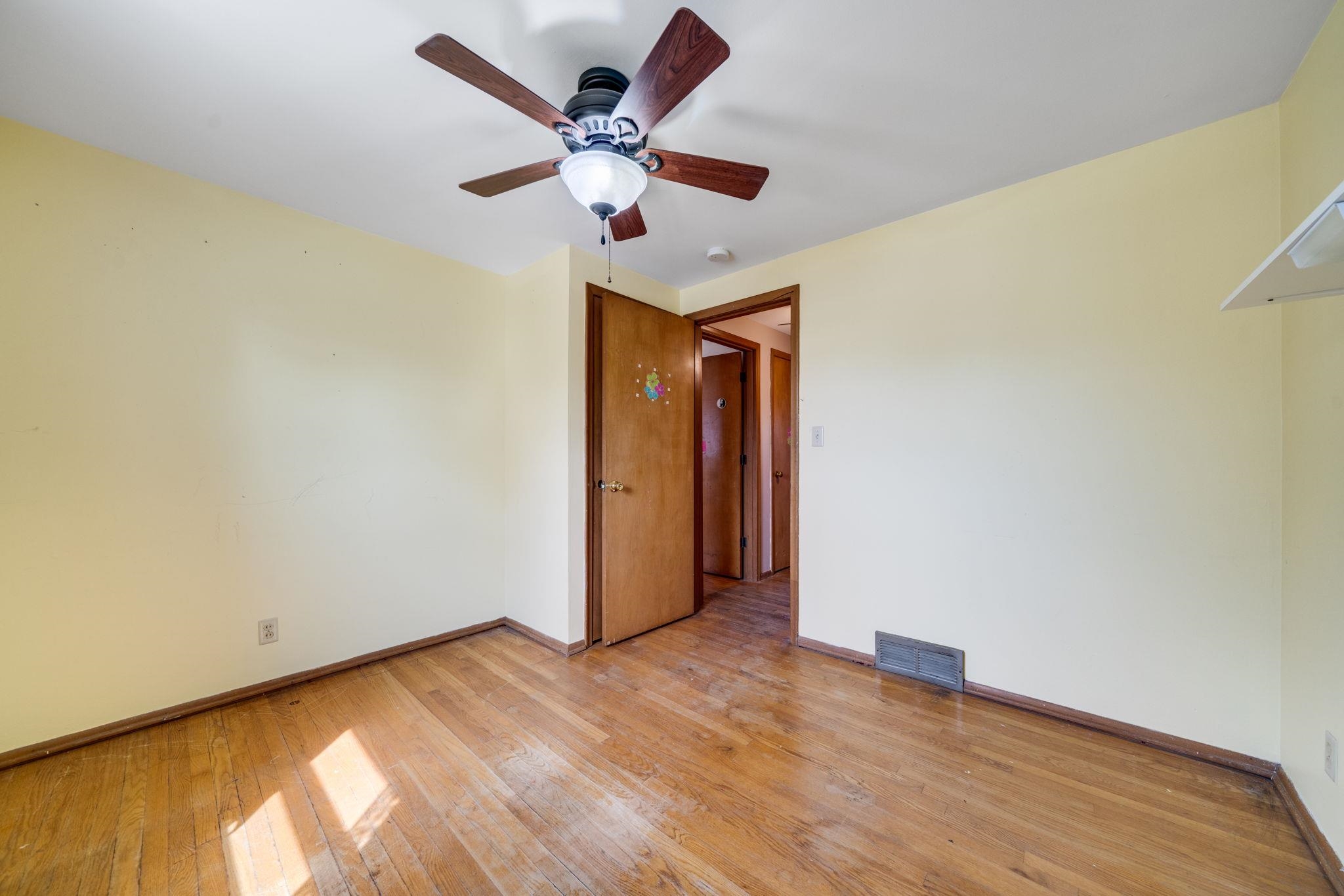 1611 Notre Dame Road Rockford, IL 61103 - Photo 13 of 33 an empty room with wooden floor and a ceiling fan