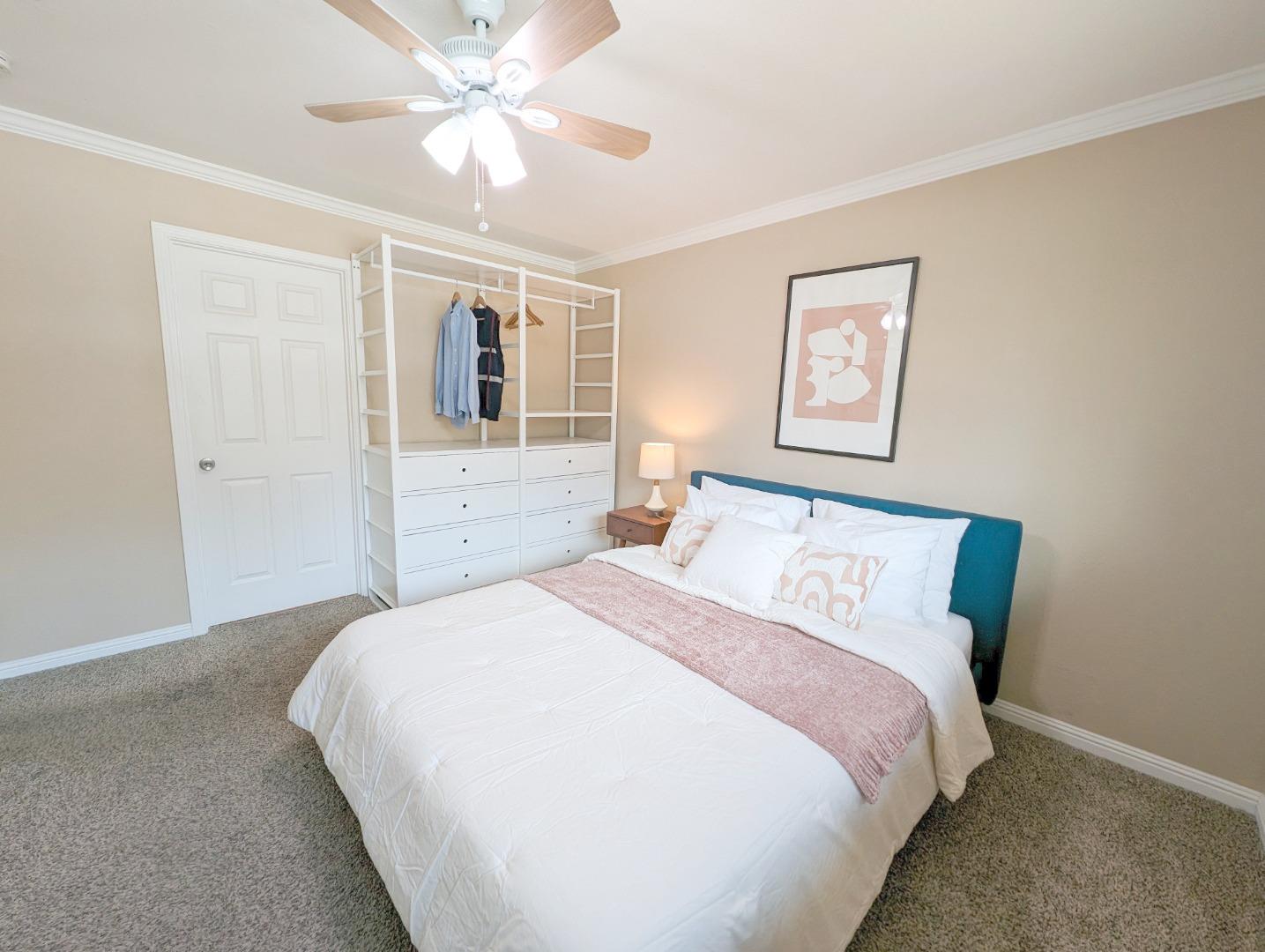 205 Compton Circle, Unit B San Ramon, CA 94583 - Photo 12 of 24 a bedroom with a large bed and a chandelier