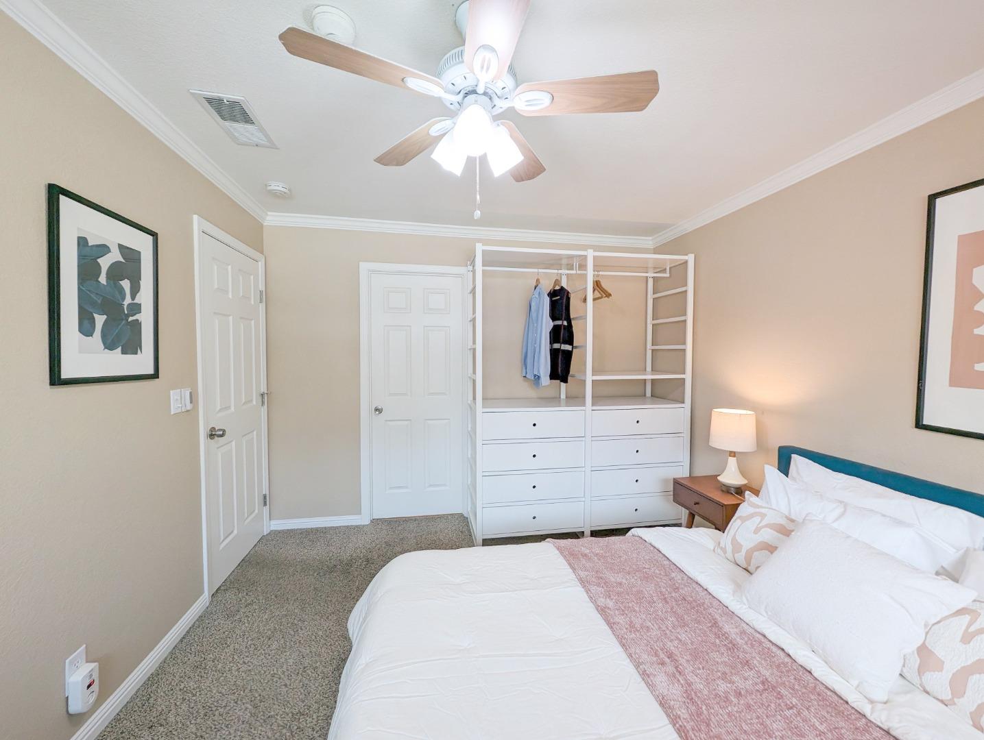 205 Compton Circle, Unit B San Ramon, CA 94583 - Photo 13 of 24 a bedroom with a large bed a chandelier and a window