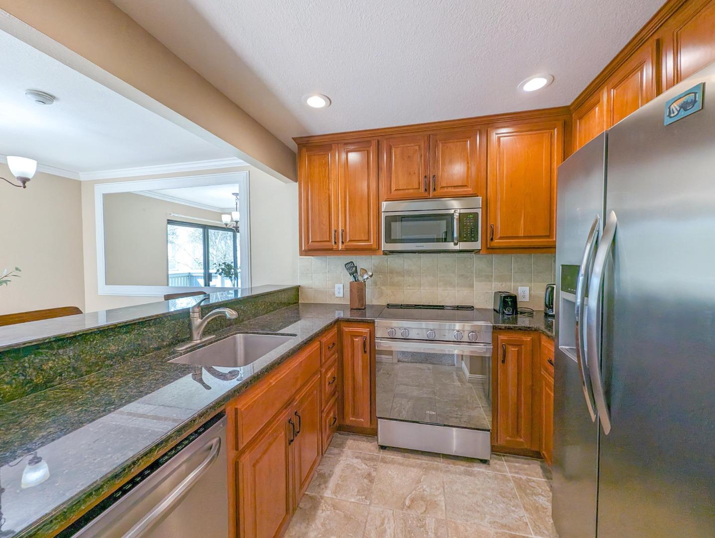 205 Compton Circle, Unit B San Ramon, CA 94583 - Photo 8 of 24 a kitchen with stainless steel appliances granite countertop a sink stove and refrigerator