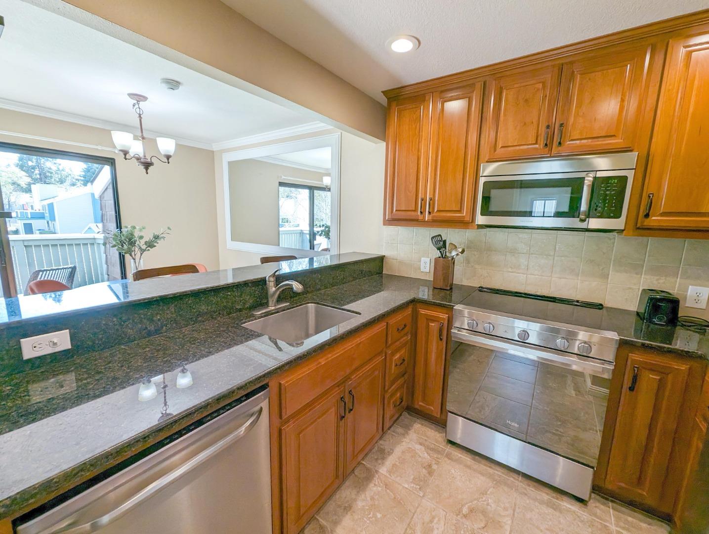 205 Compton Circle, Unit B San Ramon, CA 94583 - Photo 9 of 24 a kitchen with granite countertop a sink stove and cabinets