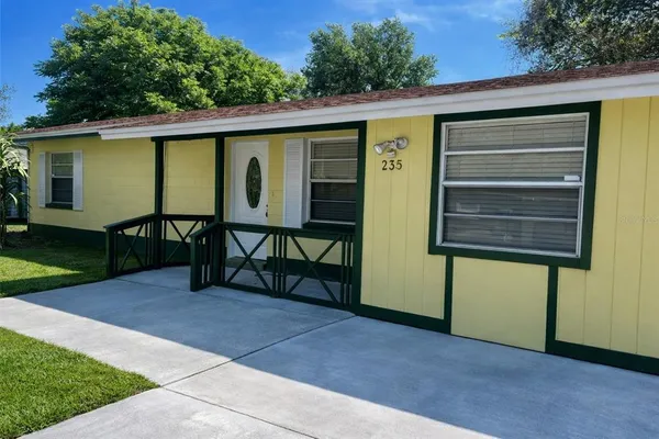 a view of a house with a backyard