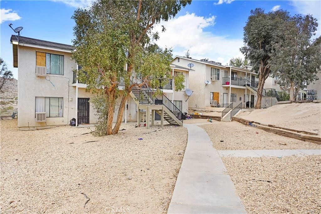 17802 Quantico Road Apple Valley, CA 92307 - Photo 5 of 21 a view of a backyard with a tree