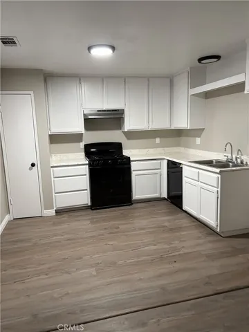 a kitchen with wooden cabinets and stainless steel appliances