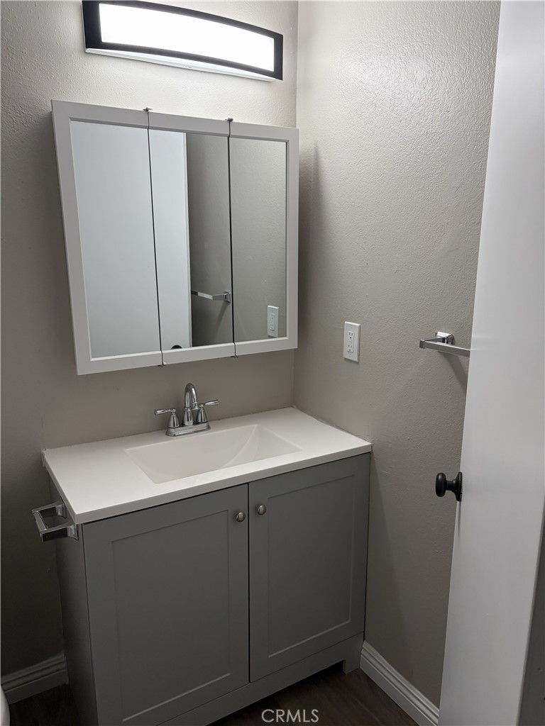 17802 Quantico Road Apple Valley, CA 92307 - Photo 7 of 21 a bathroom with a sink and a mirror