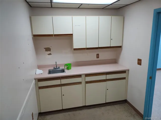 a kitchen with cabinets and white appliances