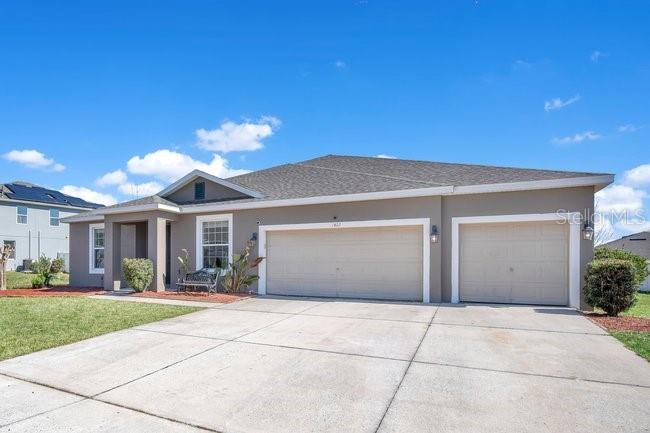1422 Sharon Rose Trace Deltona, FL 32725 - Photo 2 of 42 a view of a house with a yard and potted plants