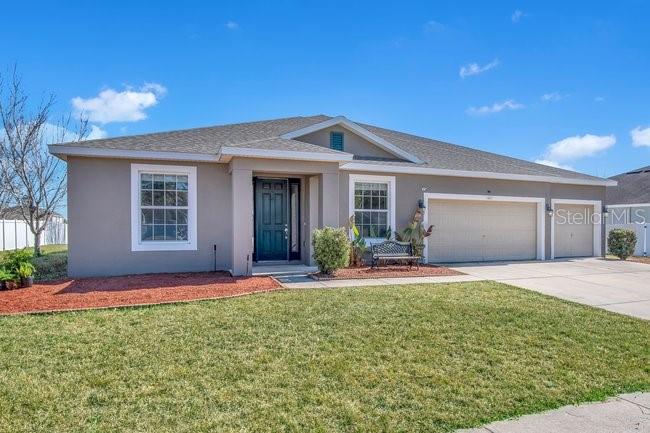 1422 Sharon Rose Trace Deltona, FL 32725 - Photo 22 of 42 a front view of a house with a yard and garage