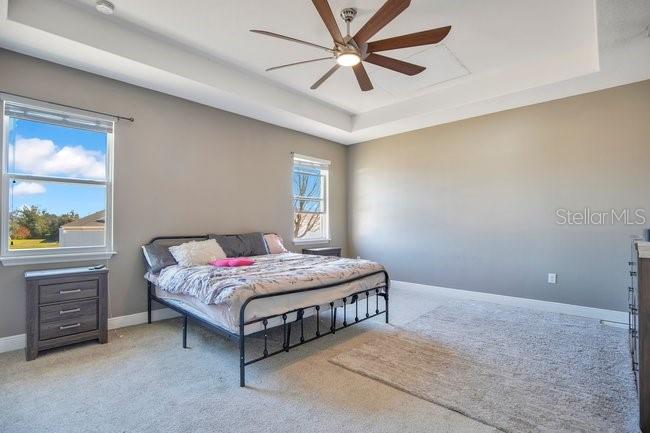 1422 Sharon Rose Trace Deltona, FL 32725 - Photo 26 of 42 a bedroom with a bed and a chandelier