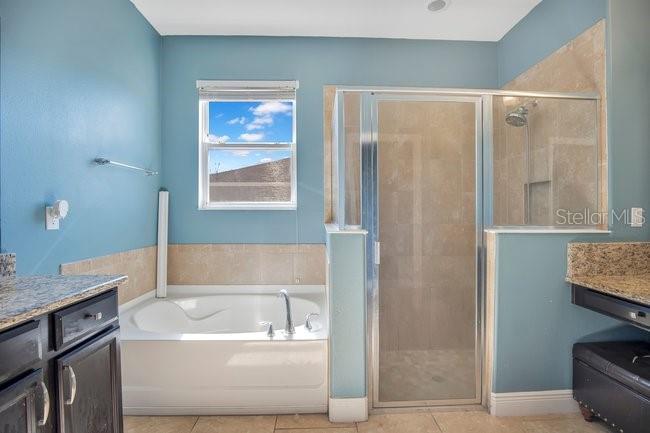 1422 Sharon Rose Trace Deltona, FL 32725 - Photo 29 of 42 a bathroom with a bathtub and a shower