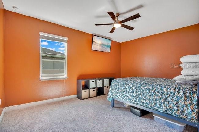 1422 Sharon Rose Trace Deltona, FL 32725 - Photo 30 of 42 a bedroom with a bed and a ceiling fan