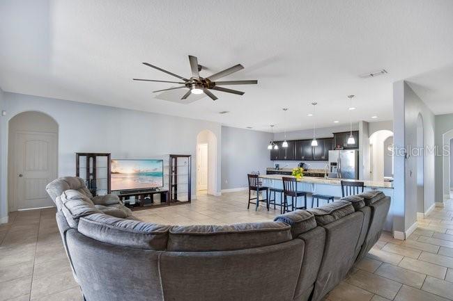 1422 Sharon Rose Trace Deltona, FL 32725 - Photo 3 of 42 a living room with furniture and a table
