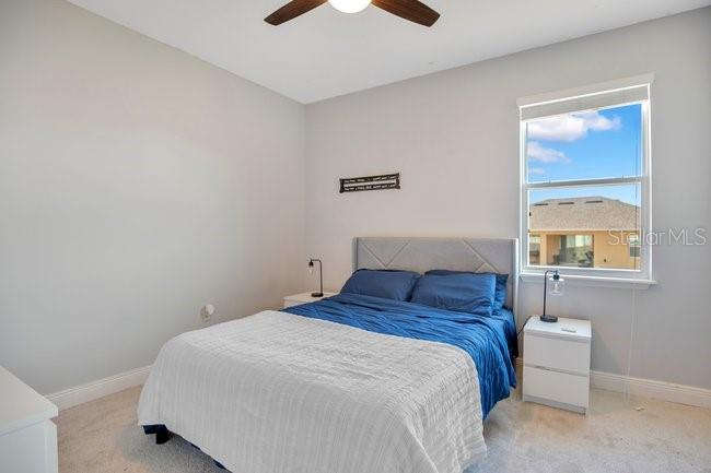 1422 Sharon Rose Trace Deltona, FL 32725 - Photo 31 of 42 a bedroom with a bed and a painting on the wall