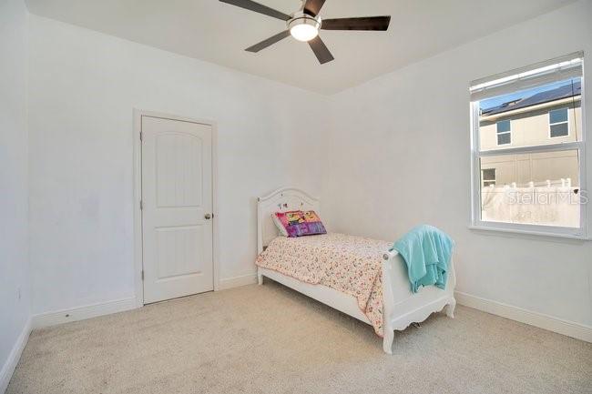 1422 Sharon Rose Trace Deltona, FL 32725 - Photo 33 of 42 a room with a bed and window