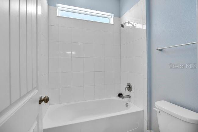 1422 Sharon Rose Trace Deltona, FL 32725 - Photo 34 of 42 a bathroom with a bathtub and shower