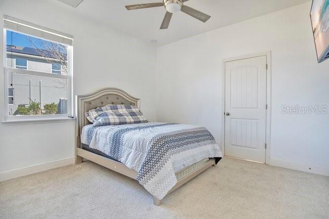 1422 Sharon Rose Trace Deltona, FL 32725 - Photo 36 of 42 a bedroom with a bed and window