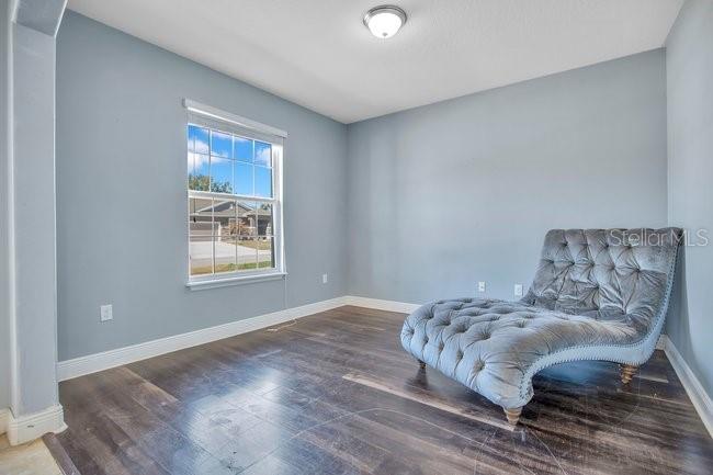 1422 Sharon Rose Trace Deltona, FL 32725 - Photo 39 of 42 a bedroom with a bed and wooden floor