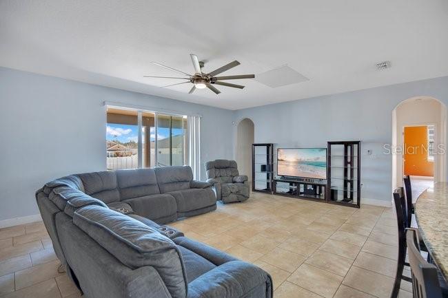 1422 Sharon Rose Trace Deltona, FL 32725 - Photo 4 of 42 a living room with furniture and a flat screen tv with fireplace