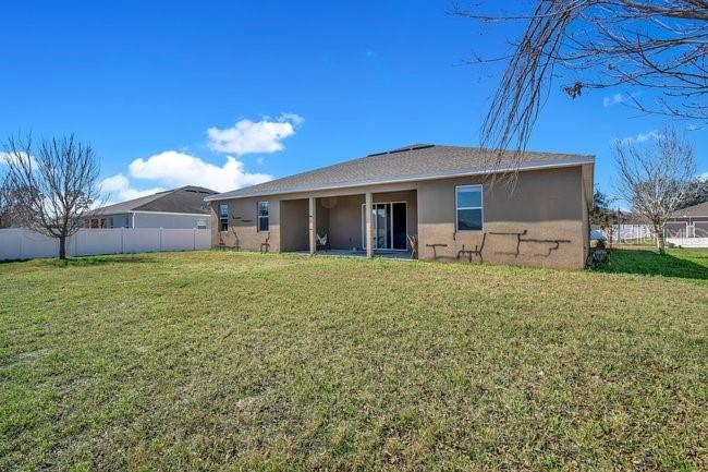 1422 Sharon Rose Trace Deltona, FL 32725 - Photo 10 of 42 a front view of a house with garden