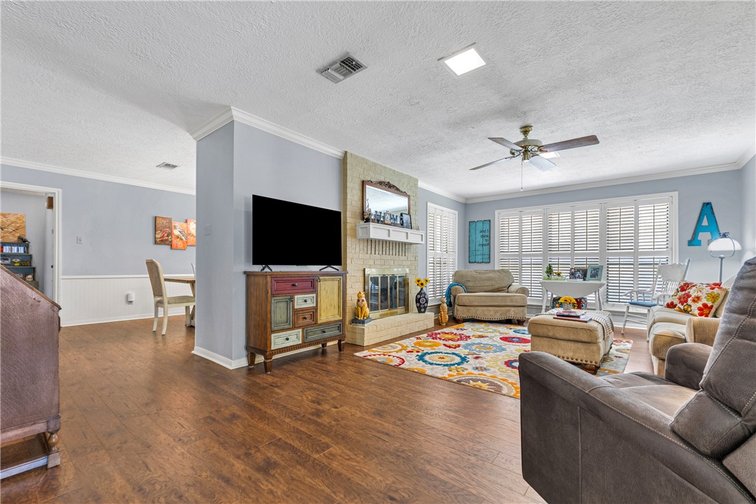 2911 Braeburn Street Bryan, TX 77802 - Photo 8 of 30 Spacious Living Area with Fireplace and Shutters and Lots of Natural Light.