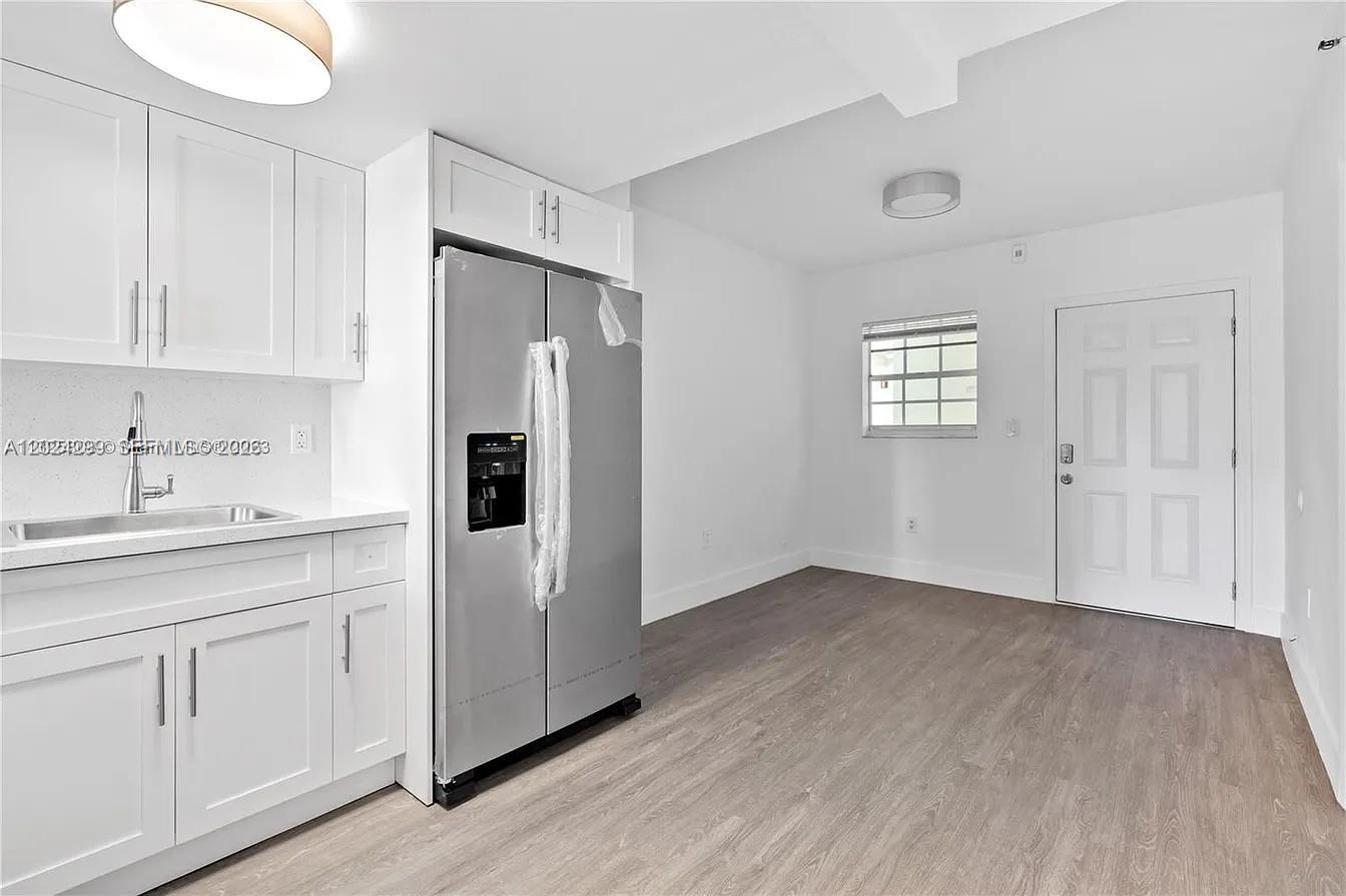 1351 Southwest 4th Street, Unit 8 Miami, FL 33135 - Photo 4 of 11 a view of cabinets and wooden floor