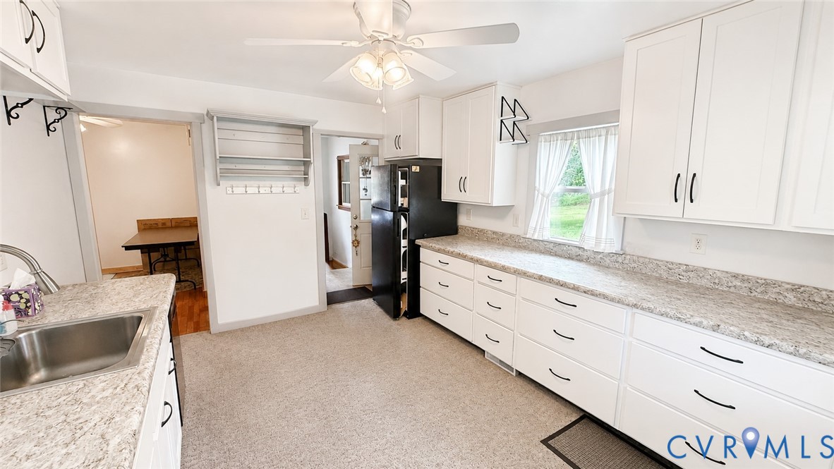 5560 West Hoover Road Reva, VA 22735 - Photo 21 of 32 Kitchen featuring white cabinetry, light-toned cou
