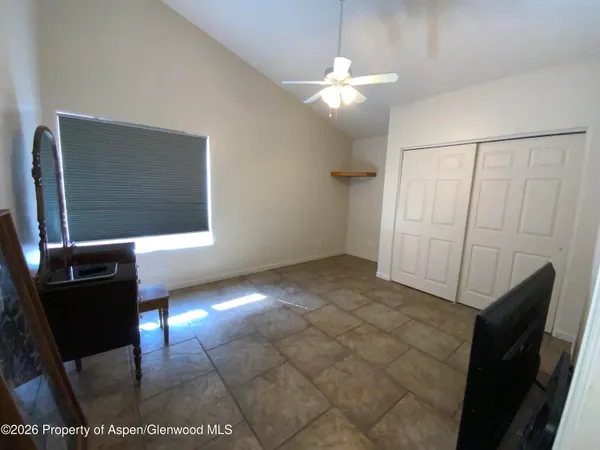 a view of a livingroom with furniture and an empty room
