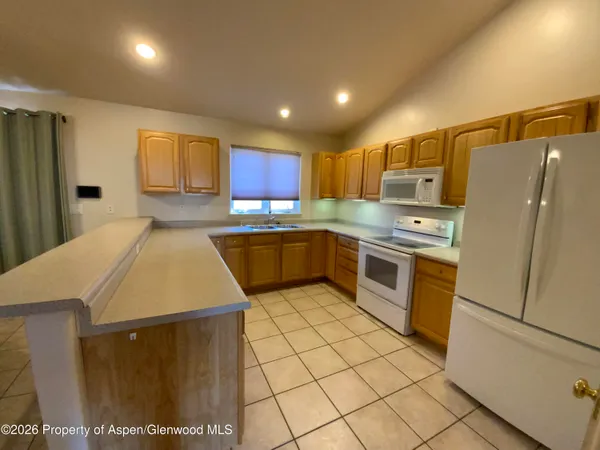 a kitchen with stainless steel appliances a refrigerator sink stove microwave and cabinets