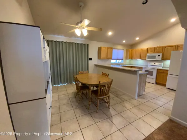 a kitchen with a table and chairs in it