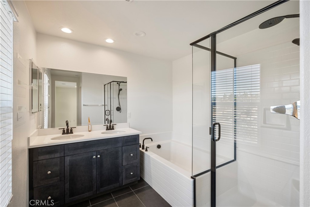 9605 Bonsai Lane Riverside, CA 92508 - Photo 17 of 41 a spacious bathroom with a double vanity sink a mirror and shower