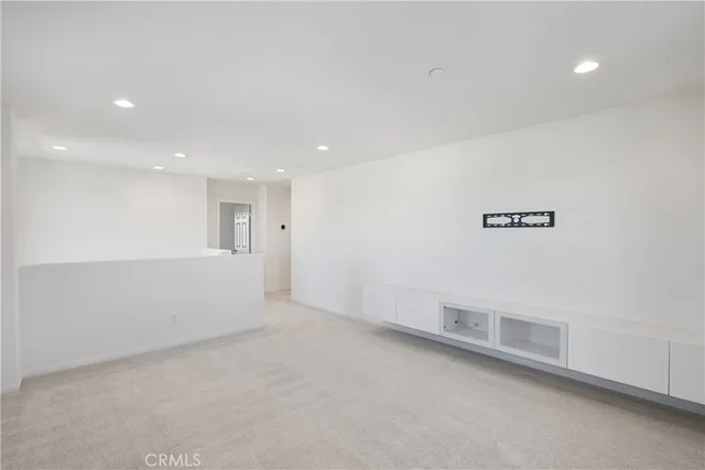 an empty room with a empty space and windows