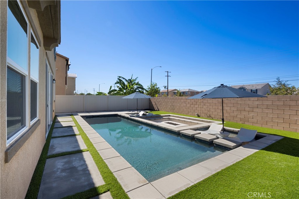 9605 Bonsai Lane Riverside, CA 92508 - Photo 31 of 41 a view of a swimming pool with a table and chairs