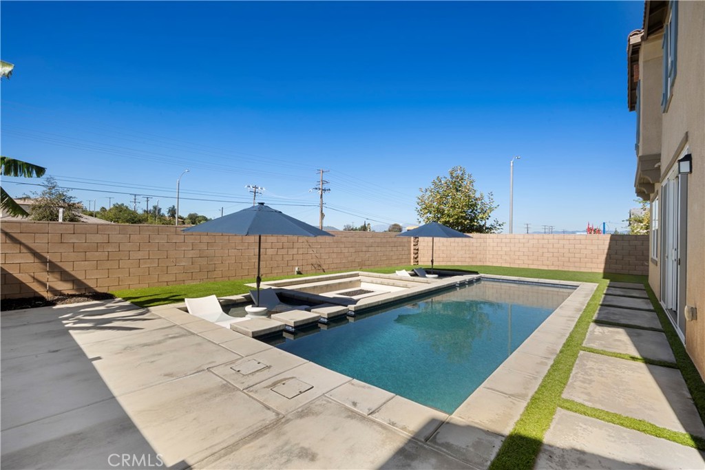 9605 Bonsai Lane Riverside, CA 92508 - Photo 32 of 41 a view of a swimming pool with a lounge chairs